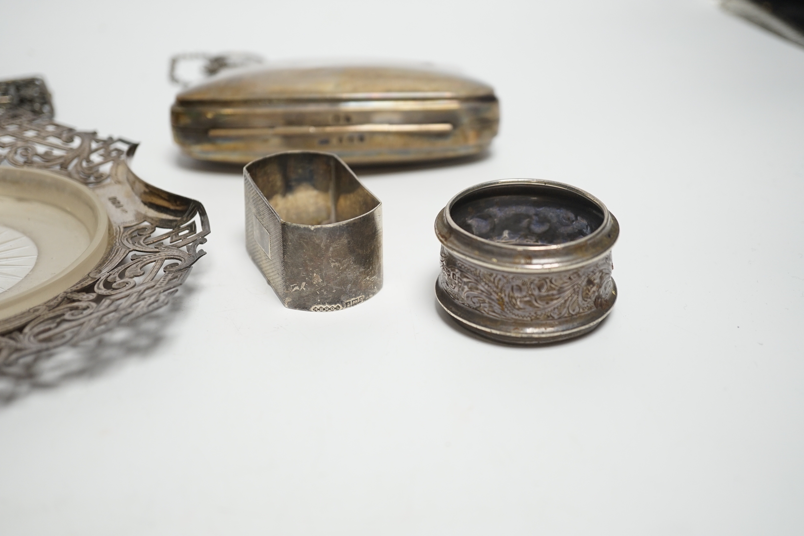 A pair of Edwardian silver mounted posy vases, Birmingham, 1902, weighted, 11.1cm, a silver purse, two silver napkin rings, silver butter dish stand, a silver belt buckle and a pair of plated sugar tongs.